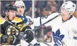  ?? MADDIE MEYER GETTY IMAGES ?? The Bruins’ Brad Marchand tussles with Leafs defenceman Nikita Zaitsev during the first period Saturday.