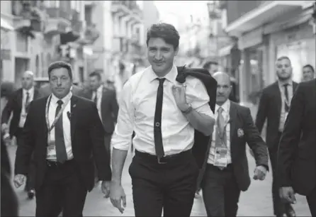  ?? SEAN KILPATRICK, THE CANADIAN PRESS ?? Prime Minister Justin Trudeau walks through the town of Taormina, Italy, Friday as he attends the G7 summit.