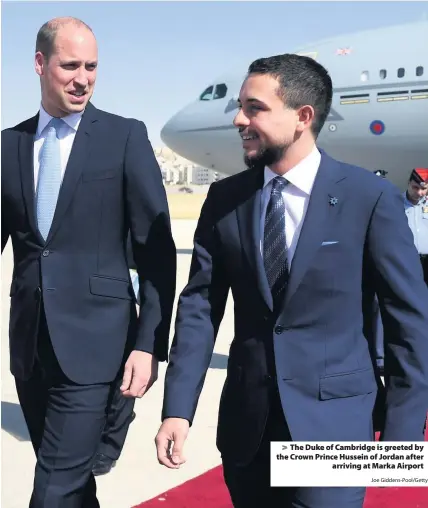  ?? Joe Giddens-Pool/Getty ?? > The Duke of Cambridge is greeted by the Crown Prince Hussein of Jordan after arriving at Marka Airport