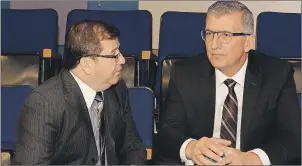  ?? JOE GIBBONS/THE TELEGRAM ?? Former Premier Paul Davis (right) speaks with his lawyer, Tommy Williams, before Davis took the witness seat Friday at the Dunphy Inquiry.