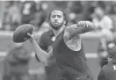  ?? RICK OSENTOSKI/USA TODAY SPORTS ?? Colin Kaepernick passes during halftime at the Michigan football spring game at Michigan Stadium on April 2.