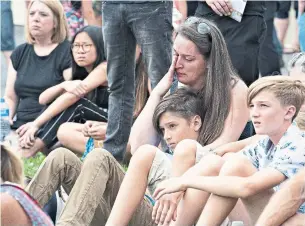  ?? JACQUES BOISSINOT THE CANADIAN PRESS ?? The funeral in Romy and Norah Carpentier’s hometown of Lévis, Que., on Monday was limited to family due to COVID concerns, but hundreds gathered to watch the ceremony on giant screens.