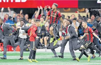 ?? DALE ZANINE/USA TODAY SPORTS ?? Atlanta United forward Josef Martinez (7) and his teammates celebrate after defeating the Portland Timbers 2-0 in the 2018 MLS Cup on Saturday.