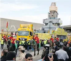  ??  ?? The statue of Ramses II is surrounded by honour guards as it is moved to a permanent location at the Grand Egyptian Museum in Cairo, Egypt.