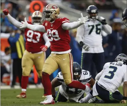  ?? PHOTOS BY NHAT V. MEYER — STAFF PHOTOGRAPH­ER ?? DeForest Buckner (99) celebrates his third-quarter sack of Russell Wilson. The pivotal play forced Seattle to settle for a tying field goal.