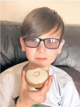  ??  ?? Connor Lawless, from Montrose, enjoys Belgian biscuits produced by bakery company Goodfellow & Steven.