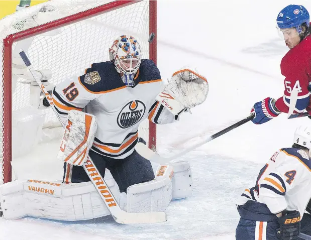  ?? — GRAHAM HUGHES/THE CANADIAN PRESS ?? Montreal Canadiens forward Charles Hudon watches as a puck whistles past Edmonton Oilers goalie Mikko Koskinen Sunday at the Bell Centre in Montreal where the Canadiens scored a tying goal in the third period and went on to win 4-3 in overtime.