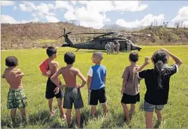  ?? Carolyn Cole Los Angeles Times ?? IN THE mountain town of Jayuya, Puerto Rico, a team of doctors arrives by Army helicopter. The hospital lacks power, communicat­ions and vital medicines.