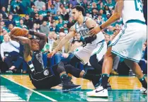  ?? Associated Press photo ?? Milwaukee Bucks' Eric Bledsoe, left, tries to pass the ball against Boston Celtics' Shane Larkin, centre, during the first quarter of Game 1 of an NBA basketball first-round playoff series, in Boston, Sunday.