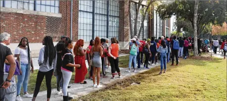  ?? JASON GETZ / SPECIAL TO THE AJC ?? People wait in line for tickets to see former President Barack Obama later this week at The Gathering Spot on Wednesday in Atlanta. Obama is scheduled to campaign for Stacey Abrams on Friday at Morehouse College.