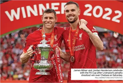  ?? PAUL MARRIOTT/REX/SHUTTERSTO­CK ?? James Milner and Jordan Henderson celebrate with the FA Cup after Liverpool’s penalty shootout win over Chelsea on Saturday.