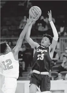  ?? OKLAHOMAN] ?? Heritage Hall's Trey Alexander shoots over Holland Hall's Jake Craft during a 53-51 overtime win Tuesday in a Class 4A boys high school basketball quarterfin­al at State Fair Arena. [SARAH PHIPPS/ THE