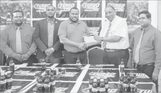  ??  ?? Petra Organizati­on Co-Director Troy Mendonca (centre) collects the sponsorshi­p cheque from Robert Selman (second from right), General Manager of the Guyana Beverage Company. Also in the photo are GFF President Wayne Forde (second from left), Samuel...