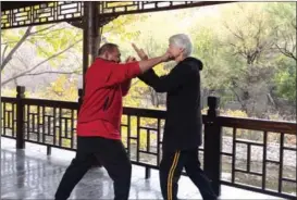  ??  ?? Brahm practices with Cheng Hejing, a master of wing chun, a style of Chinese martial arts.