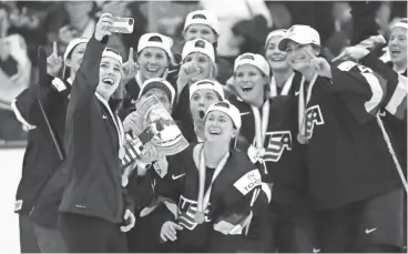  ?? CARLOS OSORIO/AP ?? The United States team poses for a selfie after overtime of the gold-medal game of the world hockey championsh­ips against Canada on Friday in Plymouth, Mich. The United States won 3-2.