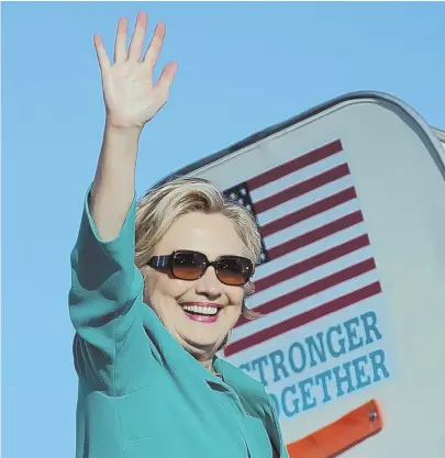  ?? AP PHOTO ?? BEST FACE FORWARD: Hillary Clinton waves while leaving Daytona Beach, Fla., yesterday. FBI Director James B. Comey’s statement to Congress about additional emails is being seen as a political bombshell.