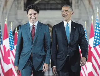  ?? PAUL CHIASSON THE CANADIAN PRESS ?? U.S. President Barack Obama and Prime Minister Justin Trudeau walk down the Hall of Honour on Parliament Hill, in Ottawa, in 2016. The former president is urging Canadians to re-elect Trudeau.