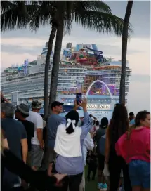  ?? — AFP photo ?? People watch as Royal Caribbean’s “Icon of the Seas,” billed as the world’s largest cruise ship, sails from the Port of Miami in Miami, Florida, on its maiden cruise.