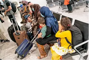  ?? Pic: WPA Pool ?? Refugees from Afghanista­n wait to be processed after arriving on an evacuation flight at Heathrow Airport
