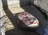  ?? WCVB ?? The iconic Plymouth Rock and other sites were covered in red graffiti Monday during a vandalism spree discovered at the site marking the landing of the Pilgrims in Massachuse­tts 400 years ago.