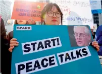  ?? AFP ?? A South Korean anti-war activist holds a placard showing a portrait of Tillerson during a rally against the planned deployment of the US-built THAAD anti-ballistic missile system, in Seoul. —