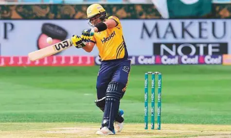  ?? Atiq ur Rehman/Gulf News ?? Kamran Akmal of Peshawar Zalmi in full cry during the match against Islamabad United at Dubai Internatio­nal Cricket Stadium yesterday. Akmal scored a breezy half-century to get Peshawar off to a brisk start.