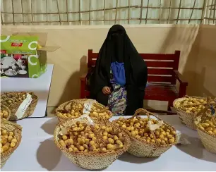  ??  ?? A woman selling dates at the Liwa Date Festival last year. Running since 2005, the date festival has provided full support for Liwa to underscore its geographic­al, social and cultural prominence.