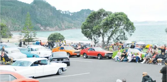  ??  ?? Thousands line the route to watch the annual drive to Onemana, north of Whangamata.