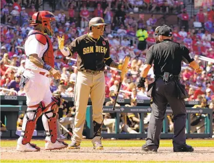  ?? JEFF ROBERSON AP ?? Manny Machado questions home plate umpire Lance Barksdale after striking out, as Cardinals catcher Yadier Molina looks on in the seventh inning Monday. Barksdale ruled Machado foul-tipped the ball and interfered with Molina as he tried to throw out a runner.