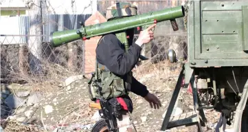  ?? — Reuters photo ?? An Indian Army soldier carries a rocket launcher near the site of a gun battle between suspected militants and Indian security forces in Pinglan village in south Kashmir’s Pulwama district.