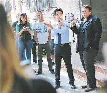  ?? Jay L. Clendenin Los Angeles Times ?? THEN- L. A. City Council candidate David Ryu, second from right, speaks in April at a rally for Villa Carlotta residents. Ryu pledged to oppose turning the Hollywood apartment building into a hotel.