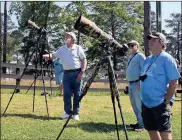  ?? Doug Walker / RN-T ?? Bill Cameron (from left) of Rome, John Wehner of Euharlee and Alan Scott Lincoln of Alabama aim cameras with long lenses at one of the Berry bald eagles Saturday.