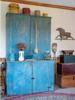  ??  ?? Top: A cherished stepback cupboard in the living room with original blue paint exemplifie­s one of Kimberly’s display tips. “Using the largest item on the left to the smallest on the right flows better and feels more natural to the eye,” she explains. The jar of colorful marbles recalls gifts from her grandmothe­r.