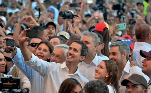  ?? AFP ?? Venezuela’s opposition leader Juan Guaido takes a selfie as his wife Fabiana Rosales (second right), Chilean President Sebastian Pinera (next to him at left), Colombian President Ivan Duque (back) and Paraguayan President Mario Abdo Benitez (right) look ob during the Venezuela aid concert in Cucuta, Colombia. —