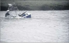  ?? ANNIE RICE — CORPUS CHRISTI CALLER-TIMES VIA AP ?? A boat sinks in the Packery Channel during Hurricane Hanna, Saturday, July 25, 2020, in North Padre Island, Texas.