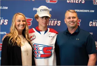  ?? ?? Future Spokane Chiefs player Mathis Preston of Penticton is pictured with his parents Natalie and Brian.