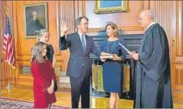  ?? AP ?? Retired Justice Anthony M Kennedy (right) administer­s the Judicial Oath to Judge Brett Kavanaugh, who is accompanie­d by his family, in the Justices' Conference Room of the US Supreme Court.