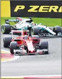  ?? (AP) ?? Ferrari driver Kimi Raikkonen of Finland (left), and Mercedes driver Lewis Hamilton of Britain steer into a corner during the Belgian Formula One Grand Prix in Spa-Francorcha­mps, Belgium on Aug 27.