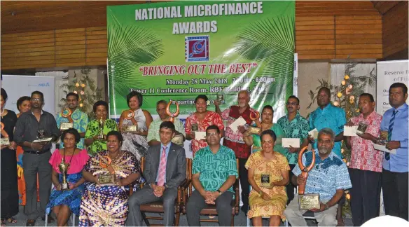  ?? Photo: Simione Haravanua. ?? The Permanent Secretary for Ministry of Industry and Trade Shaheen Ali and RBF Governor Ariff Ali with awardees during the 2017 National Microfinan­ce Awards at the RBF building on May 28,2018.