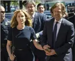  ?? JOSEPH PREZIOSO — GETTY IMAGES ?? Actress Felicity Huffman, escorted by her husband, actor William H. Macy, makes her way to the courthouse in Boston on Sept. 13. She received two weeks in prison for paying $15,000to have a test proctor inflate her daughter’s SAT score.