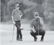  ?? PHELAN M. EBENHACK AP ?? Tiger Woods, right, and his son, Charlie, line up a putt on the 12th green during the final round of the PNC Championsh­ip golf tournament on Sunday in Orlando.