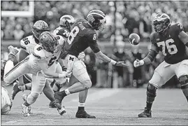  ?? BICKEL/DISPATCH] [JOSHUA A. ?? Ohio State’s Sam Hubbard forces a fumble by Michigan quarterbac­k John O’Korn that the Wolverines recovered in the third quarter.