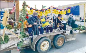  ?? (Courtesy Photo/Mallory Weaver) ?? The Gravette Lions Club float, with lighted garlands, tree and stockings proclaimin­g “Lions Serve,” won the trophy for best use of theme. Pictured are club Lion tamer Bill Mattler, president Linda Damron, treasurer Jeff Davis and member Melissa Williams.