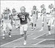  ?? Richard Shiro Associated Press ?? TRAVIS ETIENNE of Clemson runs for a touchdown during a 41-7 rout of North Carolina State.