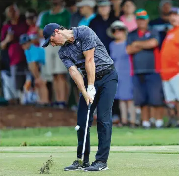  ?? KEVIN C. COX / GETTY IMAGES ?? Rory McIlroy, who shot a 4-under 66 Saturday and is tied for second, plays a shot on the fifth hole during the third round at East Lake Golf Club. McIlroy and Justin Rose are 3 shots behind Tiger Woods.