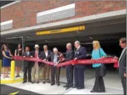  ?? RECORD FILE PHOTO ?? A group including donor Heinrich Medicus cut the ribbon for the new parking garage at Samaritan Hospital in Troy in June 2015.