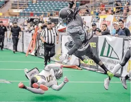  ?? ROBERTO E. ROSALES /JOURNAL ?? The Gladiators’ Jared Elmore (8) flies through the air after being hit by Wichita’s Jarrell Kelly (5) during Saturday’s game at Tingley Coliseum. Duke City prevailed to advance to the CIF semifinals.