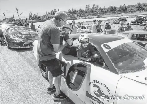  ?? FRANKIE CROWELL PHOTO ?? When the races weren’t taking place, kids got to check out the race cars during Kids Day at the Lake Doucette Motor Speedway on July 8.