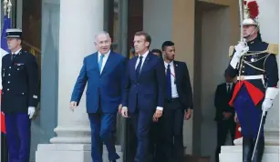  ?? (Philippe Wojazer/Reuters) ?? FRENCH PRESIDENT Emmanuel Macron escorts Prime Minister Benjamin Netanyahu as they leave the Élysée Palace in Paris yesterday.