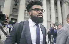  ??  ?? Ezekiel Elliott walks out of federal court Thursday in New York. He is fighting a six-game suspension by the NFL.